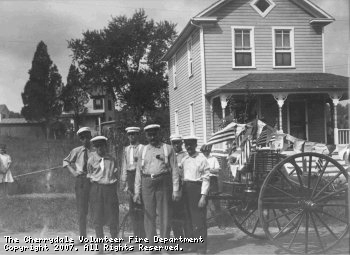 Early members of the CVFD pose with the buckets and wagons they used to fight fires.