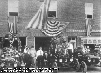 Ernest Shreve ran his business from our firehouse in the 1920's. Firefighters of the era stand outside with their decorated rigs.